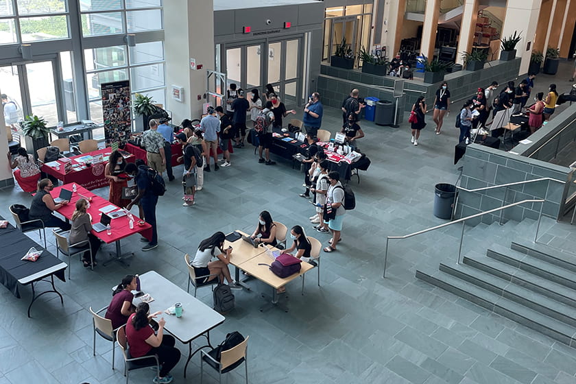 A photograph looking down into Duffield Atrium where students are mingling.