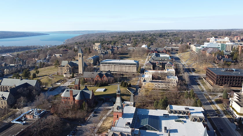 Aerial photograph of Cornell's Central Campus looking north with Cayuga Lake in the distance.