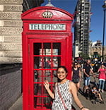 A photo of Cornell engineering student standing in front of a call box in London.