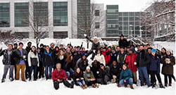 Group photo of students with their professor after having a snowball fight in physics class.