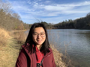Cornell Engineering student standing by a lake