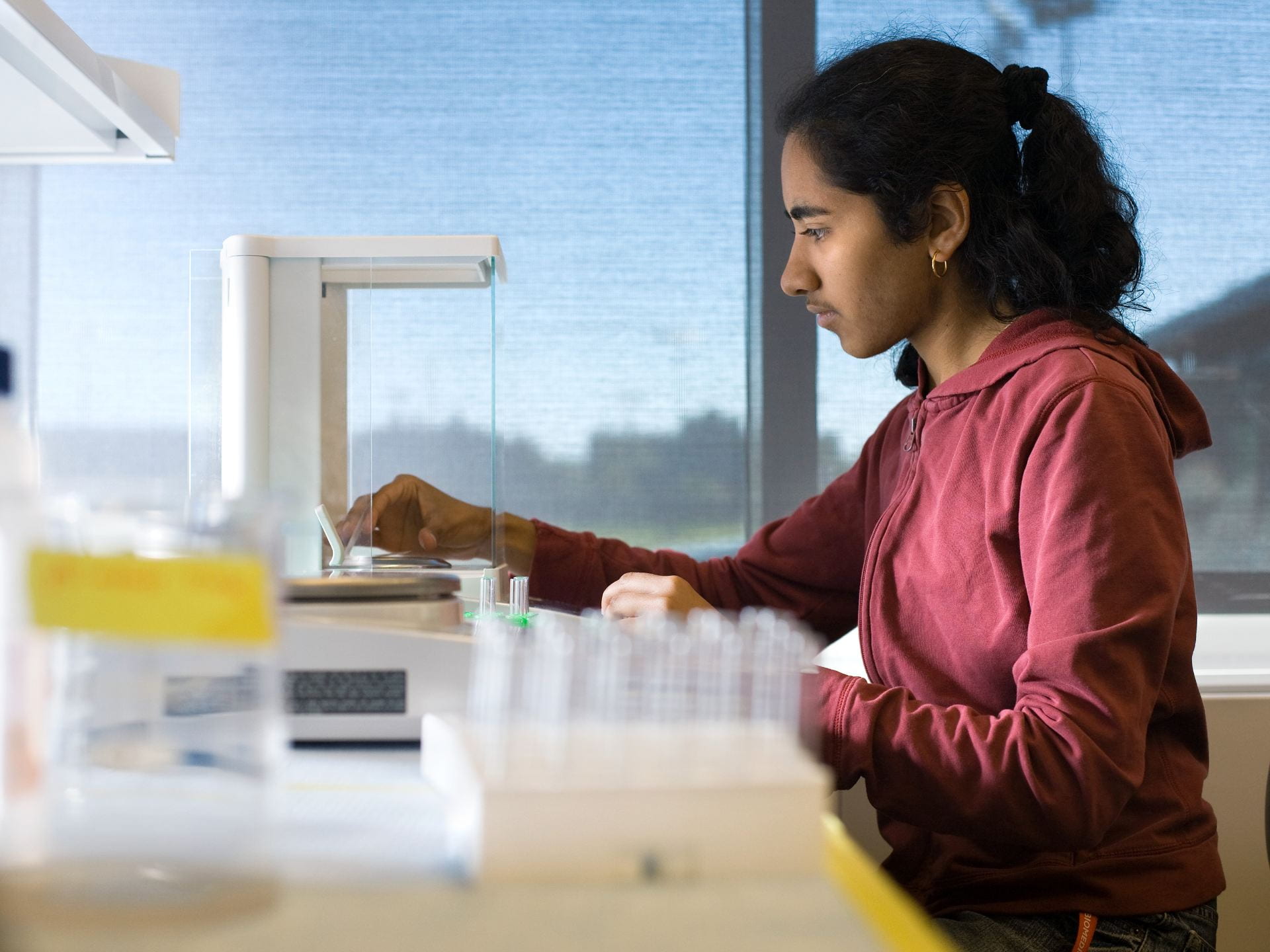 A photograph of a biomedical engineering student working in a lab