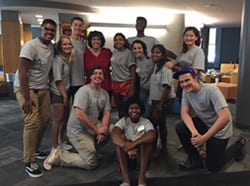 A photograph of a group of students with Cornell President Martha Pollock