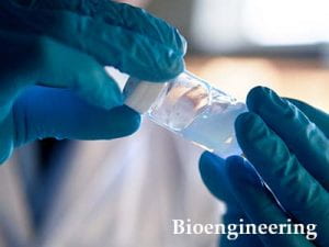 Bioengineering. A photograph of a student holding a vial of polymer